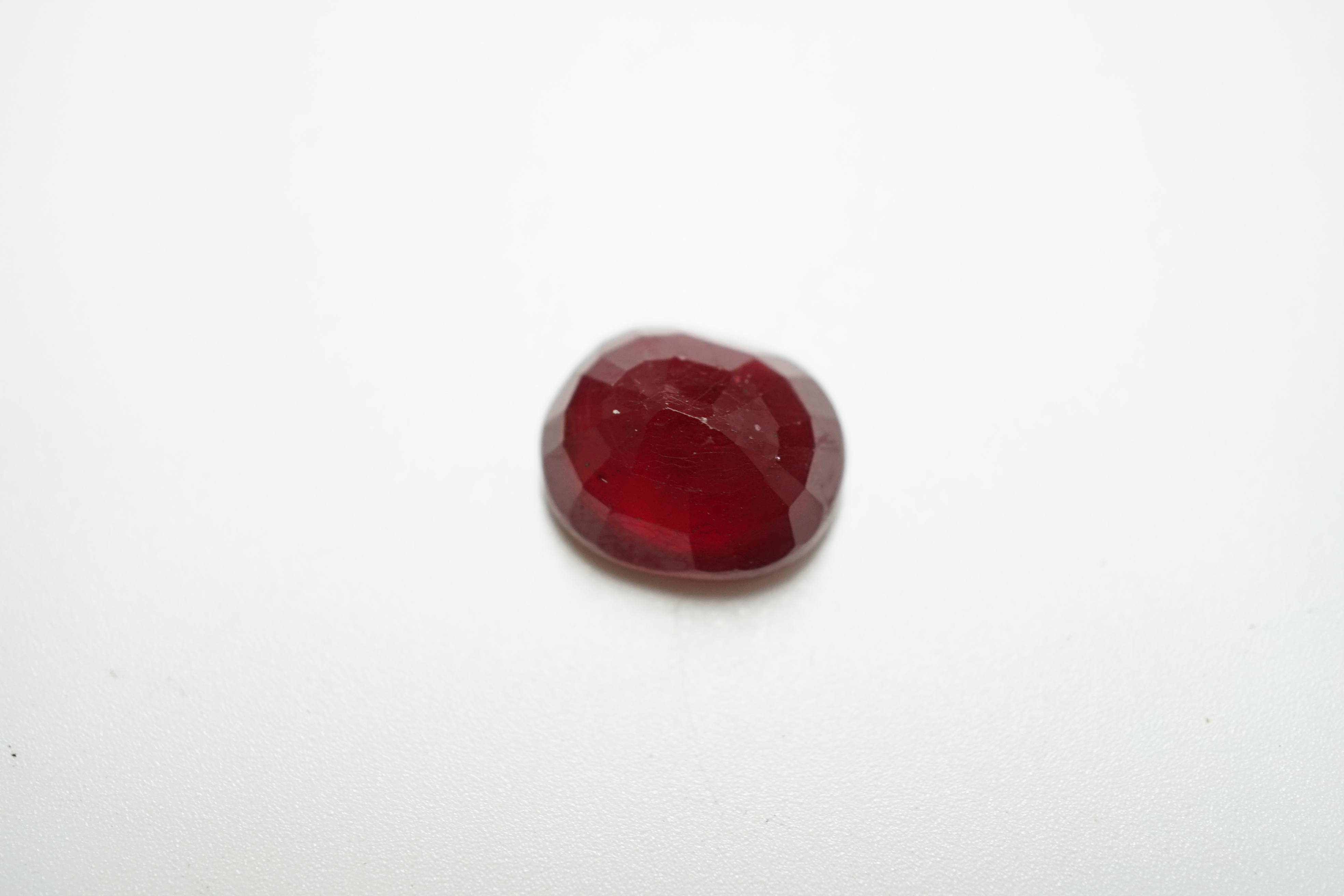 An unmounted oval cut ruby, weighing approximately 11.80ct. Condition - fair